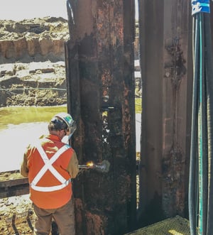 A Brennan employee works on pitting - a byproduct of galvanic corrosion.