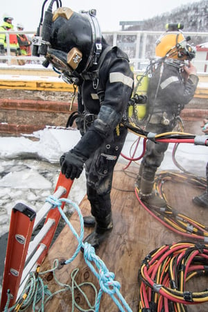 Under ice diver preparing to enter the cold water 