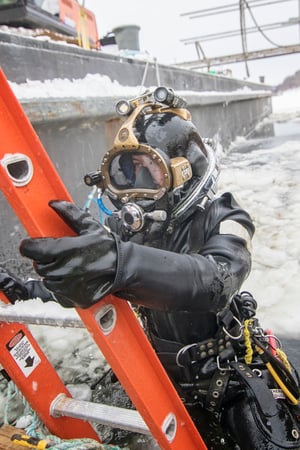 Under ice diver emerging from frozen water