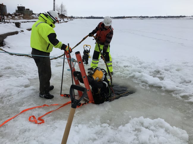 The Brennan team helps a diver into the water in Superior