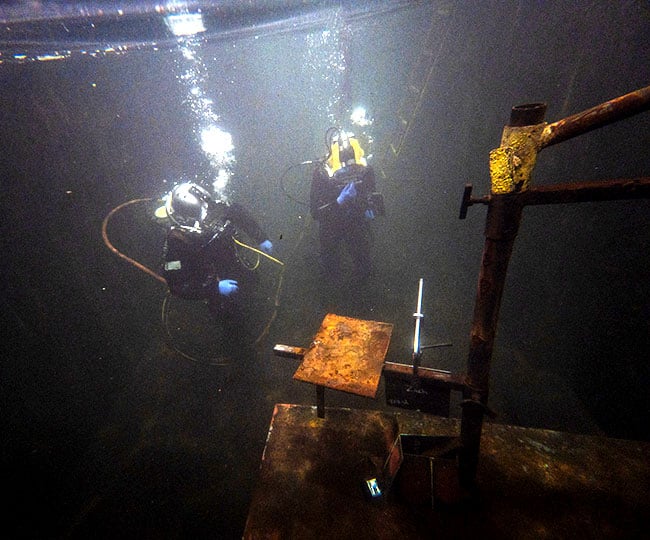 JF Brennan divers doing underwater testing and inspecting materials with different coatings.